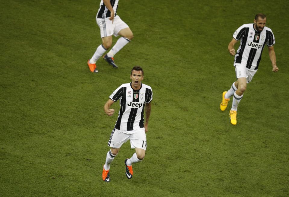 <p>Juventus’ Mario Mandzukic celebrates scoring their first goal </p>