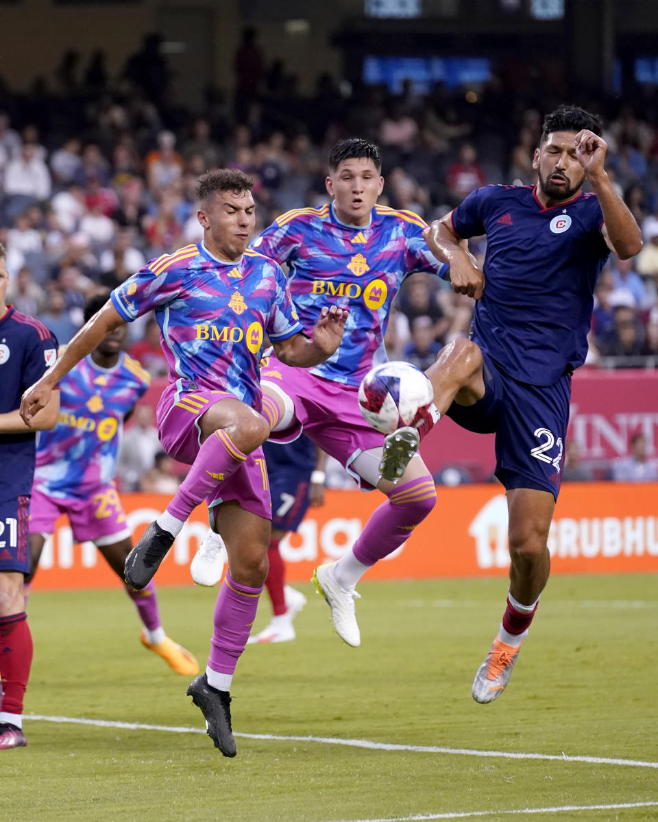 Chicago Fire defender Mauricio Pineda, right, is unable to handle a cornerkick as Toronto FC midfielder Kobe Franklin, left, defends during the first half of an MLS soccer match Saturday, July 15, 2023, in Chicago. (AP Photo/Charles Rex Arbogast)