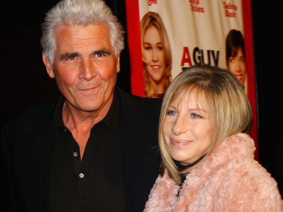 James Brolin, in a black suit, poses with Barbra Streisand, in a pink fuzzy coat, at the premiere of "A Guy Thing" in 2003.