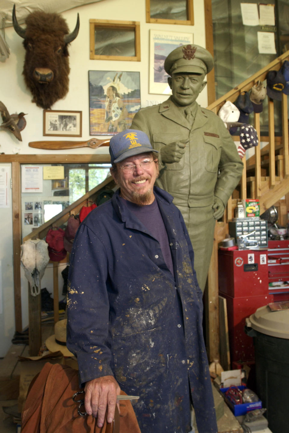 In this May 2003 photo Kansas sculptor Jim Brothers stands in his Lawrence, Kan., studio with the original clay sculpture for a bronze of President and General Dwight D. Eisenhower that was placed in the United States Capitol in June of 2003. Brothers, whose works are part of historical monuments around the country, died Tuesday, Aug. 20, 2013, at his home in Lawrence where he had been in hospice care, according to a funeral director at Warren McElwain Mortuary. He was 72. (AP Photo/Lawrence Journal World, Mike Yoder)