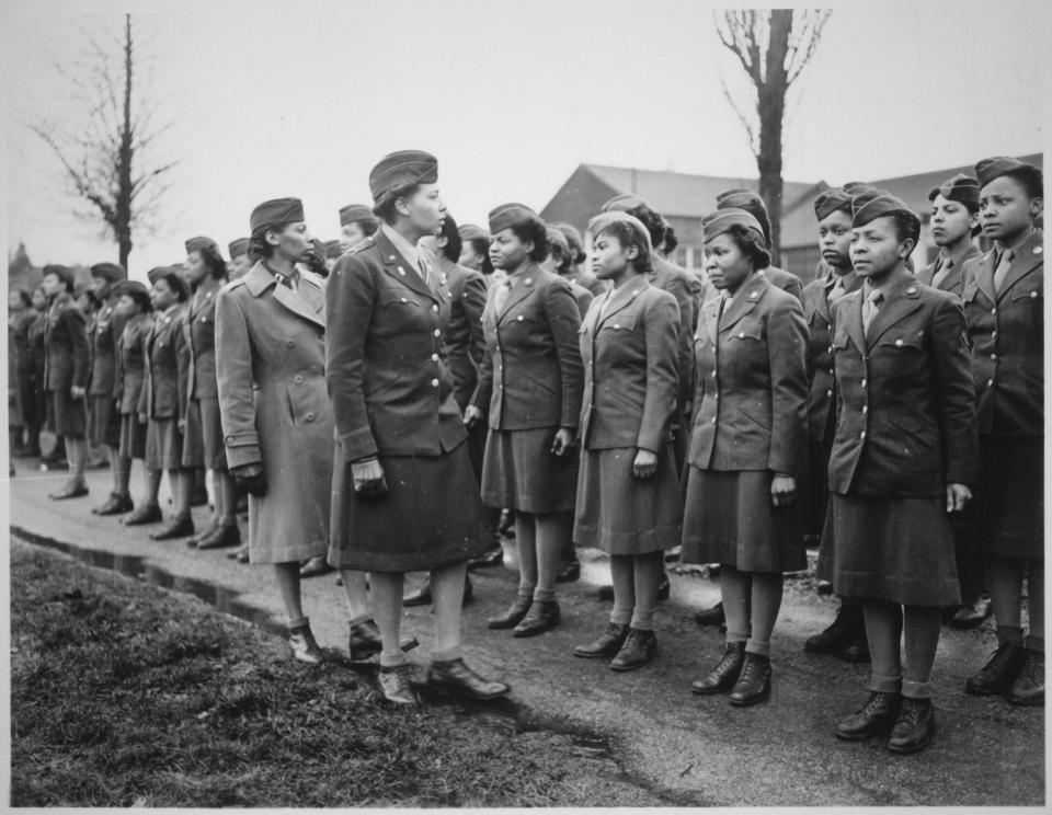 Black-and-white image of Maj. Charity Adams and Capt. Abbie N. Campbell inspecting a contingent of the Women's Army Corps.