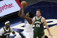 Minnesota Timberwolves' Anthony Edwards (1) lays the ball up as Milwaukee Bucks' Pat Connaughton (24) and Bobby Portis (9) watch during the second half of an NBA basketball game Wednesday, April 14, 2021, in Minneapolis. (AP Photo/Jim Mone)