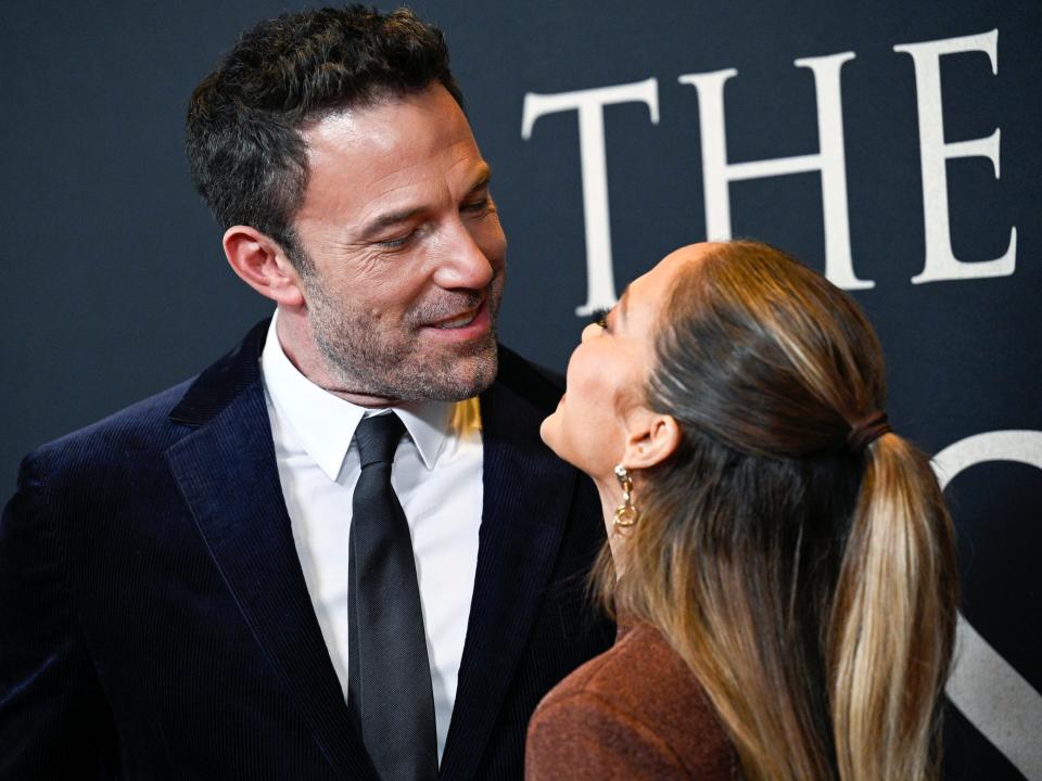 Ben Affleck smiling at Jennifer Lopez while at the premiere of "The Last Duel" in October 2021.