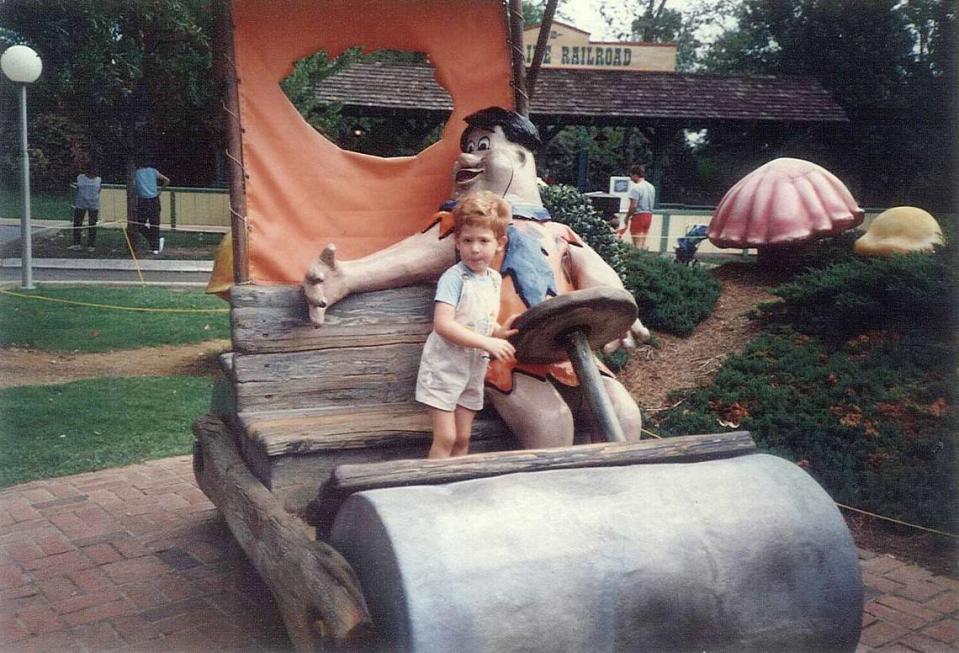 A photo shared with The Charlotte Observer of young Kurt Emsermann at Carowinds with Fred Flintstone in 1985, submitted by his mom, Doris Emsermann.