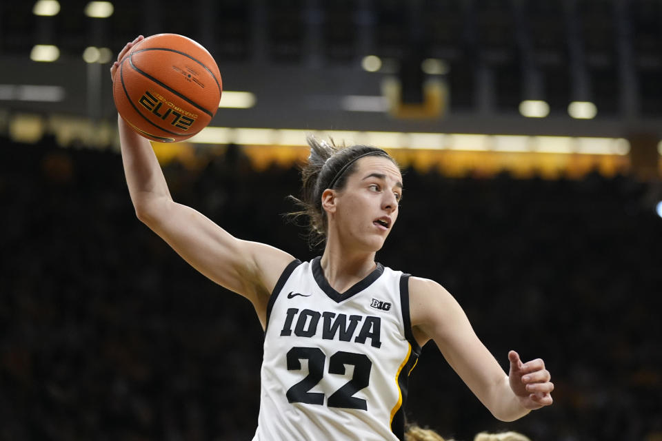 Iowa guard Caitlin Clark (22) grabs a rebound during the first half of an NCAA college basketball game against Nebraska, Saturday, Jan. 27, 2024, in Iowa City, Iowa. (AP Photo/Charlie Neibergall)