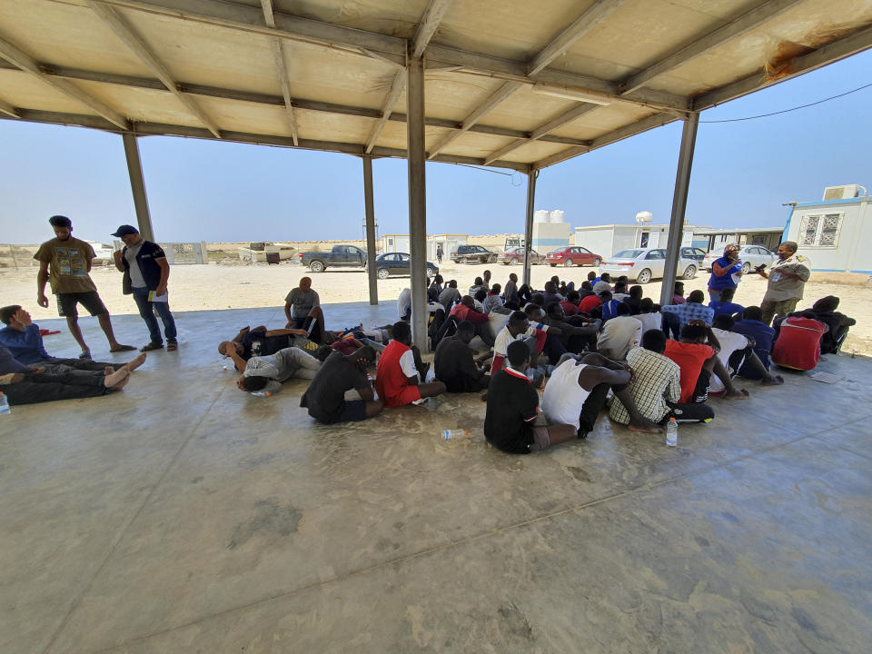 Rescued migrants rest near the city of Khoms, around 120 kilometers (75 miles) east of Tripoli, Libya., Tuesday, Aug. 27, 2019. At least 65 migrants, mostly from Sudan, were rescued, said a spokesman for Libya's coast guard, with a search halted for those still missing. The coast guard gave an estimate for those missing and feared drowned of 15 to 20 people.(AP Photo/Hazem Ahmed)