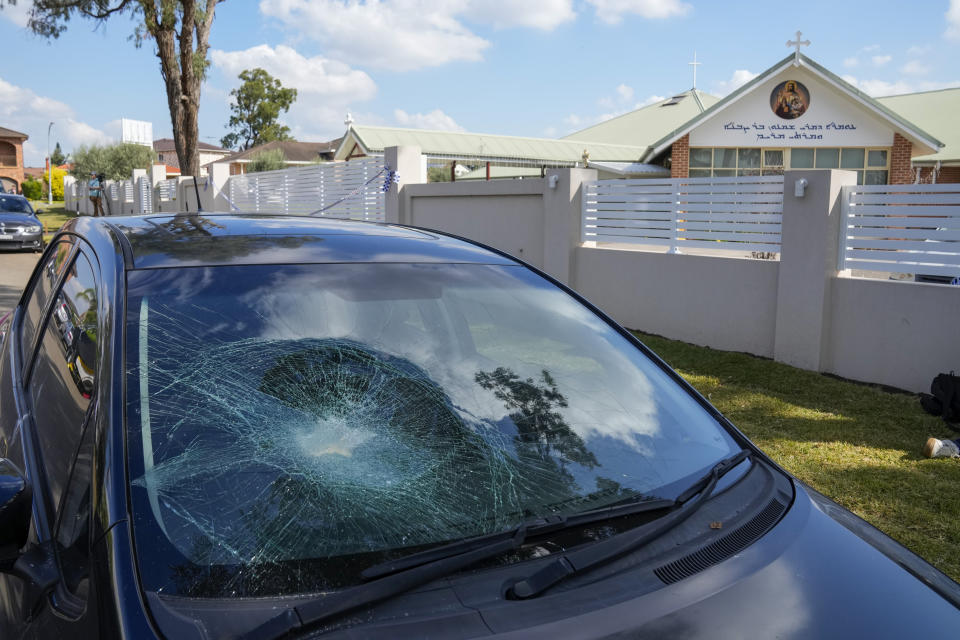 A damaged car sits parked outside the Christ the Good Shepherd church in suburban Wakely in western Sydney, Australia, Tuesday, April 16, 2024. Australian police say a knife attack in Sydney that wounded a bishop and a priest during a church service as horrified worshippers watched online and in person, and sparked a riot was an act of terrorism. (AP Photo/Mark Baker)