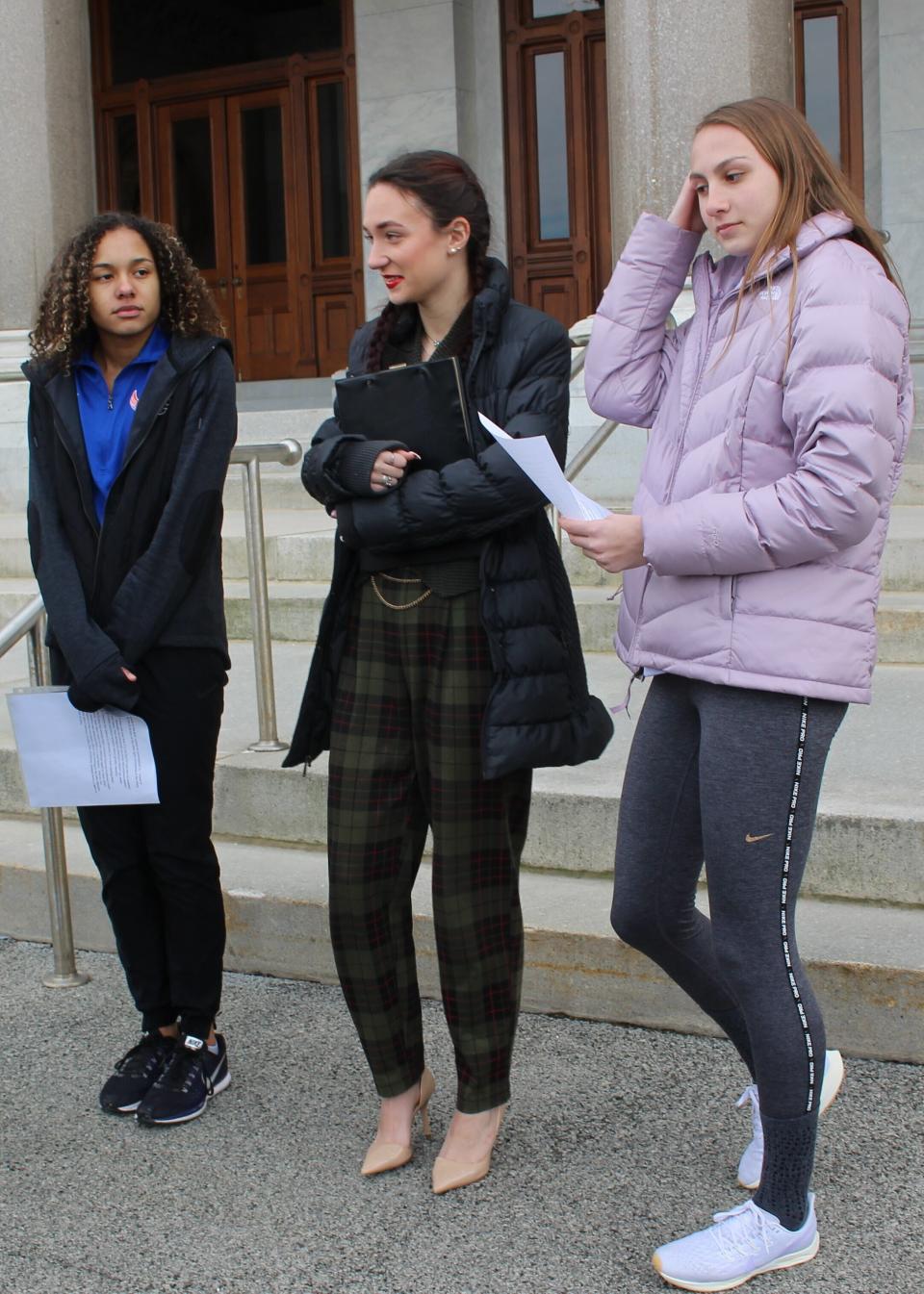 High school track athletes Alanna Smith, left, Selina Soule, center and and Chelsea Mitchell prepare to speak at a news conference outside the Connecticut State Capitol in Hartford, Conn. Wednesday, Feb. 12, 2020. The three girls have filed a federal lawsuit to block a state policy that allows transgender athletes to compete in girls sports. (AP Photo/Pat Eaton-Robb)