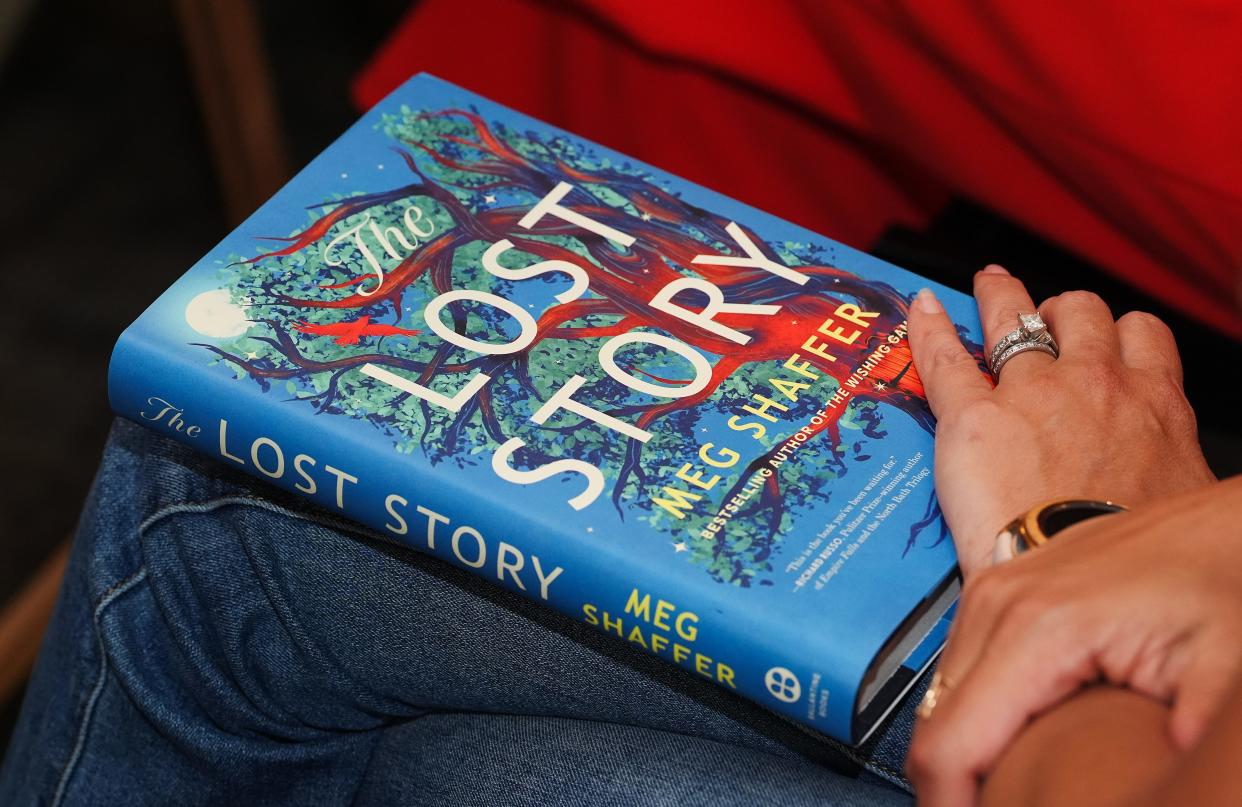 A patron sat with a copy of The Lost Story during a release party and book reading of the second novel by USA Today bestsellng author Meg Shaffer at the Carmichael's Bookstore in Louisville, Ky. on July 16, 2024. Shaffer lives in Kentucky.