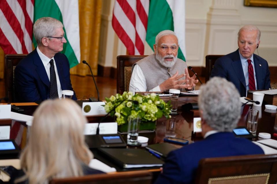 Apple CEO Tim Cook, left with India’s Prime Minister Narendra Modi and President Biden in 2023. AP