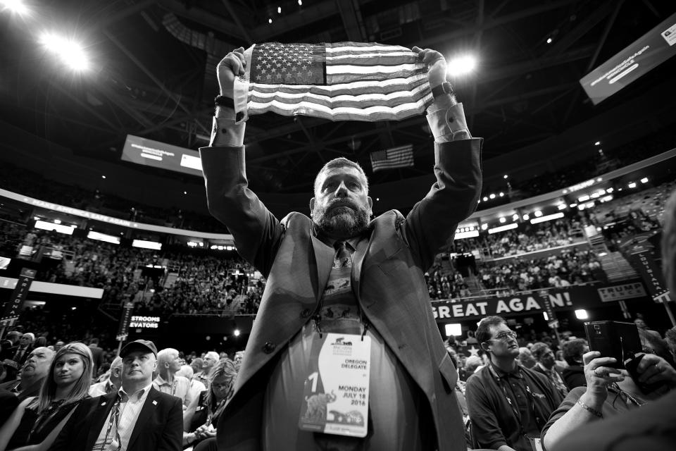 Oregon delegate Joseph Rice holds up the American flag at the Republican National Convention on Monday. (Photo: Khue Bui for Yahoo News)