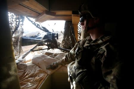 A member of the U.S. army forces takes position at the U.S. section of a base for Iraqi army and Kurdish peshmerga forces in Makhmour, southeast of Mosul. REUTERS/Khalid al Mousily