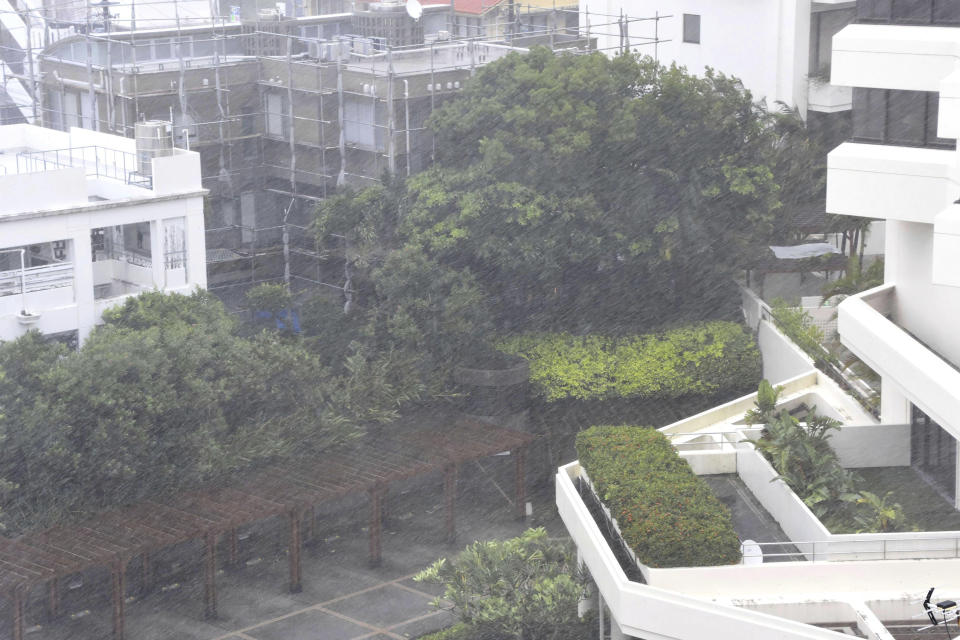 This shows a rainstorm brought by Typhoon Khanun in Naha, Okinawa prefecture, southern Japan Wednesday, Aug. 2, 2023. The powerful typhoon slammed Okinawa and other islands in southwestern Japan with high winds, damaging homes and forcing transportation to halt and stores to close as it slowly moved west. (Kyodo News via AP)