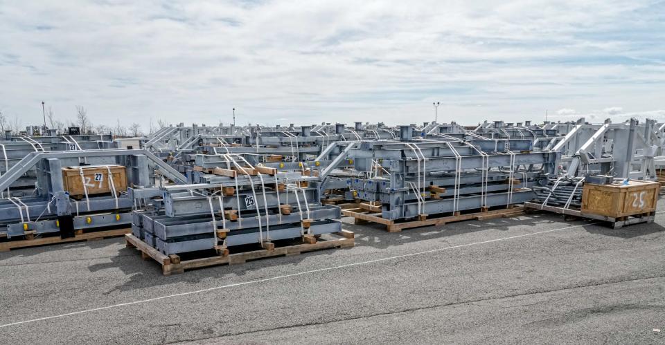 Pallets of unassembled parts for the South Fork Wind Farm cover the parking lot at the Port of Providence, where workers are assembling components for the monopile foundations that will anchor the project’s turbines.