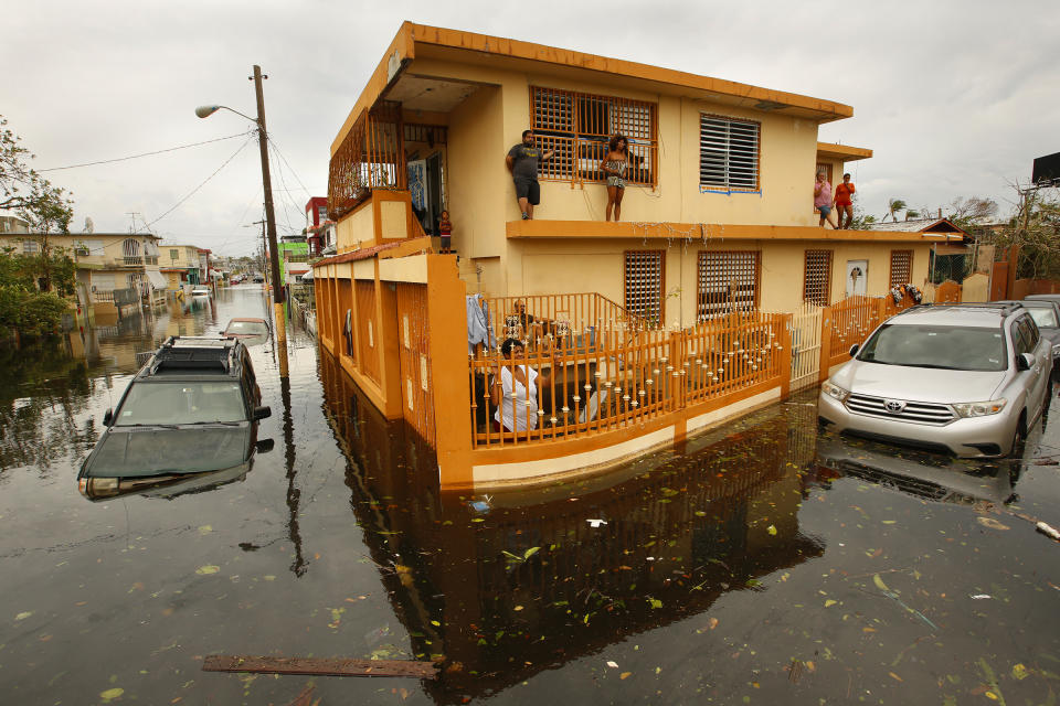 Residents of Isla Palmeras (Palmeras Island), a neighborhood in San Juan, are surrounded by water Sept. 21, 2017, the day after Hurricane Maria hit Puerto Rico. (Photo: Carolyn Cole/Los Angeles Times via Getty Images)