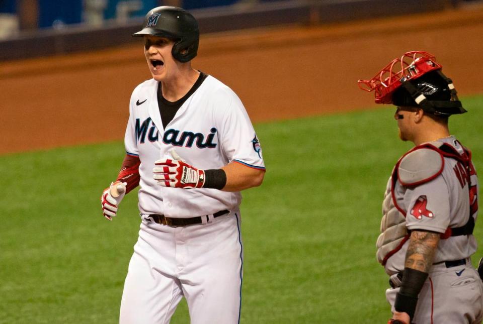 Boston Red Sox catcher Christian Vázquez (7) looks on as Miami Marlins first baseman Garrett Cooper (26) reacts after hitting a two run home run during the first inning of a baseball game at at Marlins Park in Miami on Wednesday, September 16, 2020.