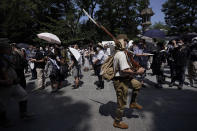 A visitor in Japanese Imperial army uniforms walks near Yasukuni Shrine, which honors Japan's war dead, Saturday, Aug. 15, 2020, in Tokyo. Japan marked the 75th anniversary of the end of World War II. (AP Photo/Eugene Hoshiko)