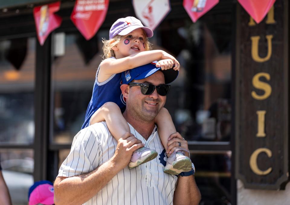 A man carrying a girl on shoulders goes to a Chicago Cubs' game in Chicago, the United States, on June 11, 2021. U.S. Midwest state of Illinois, including the country's third largest city of Chicago, fully reopened on Friday amid jitters. (Photo by Joel Lerner/Xinhua via Getty Images)