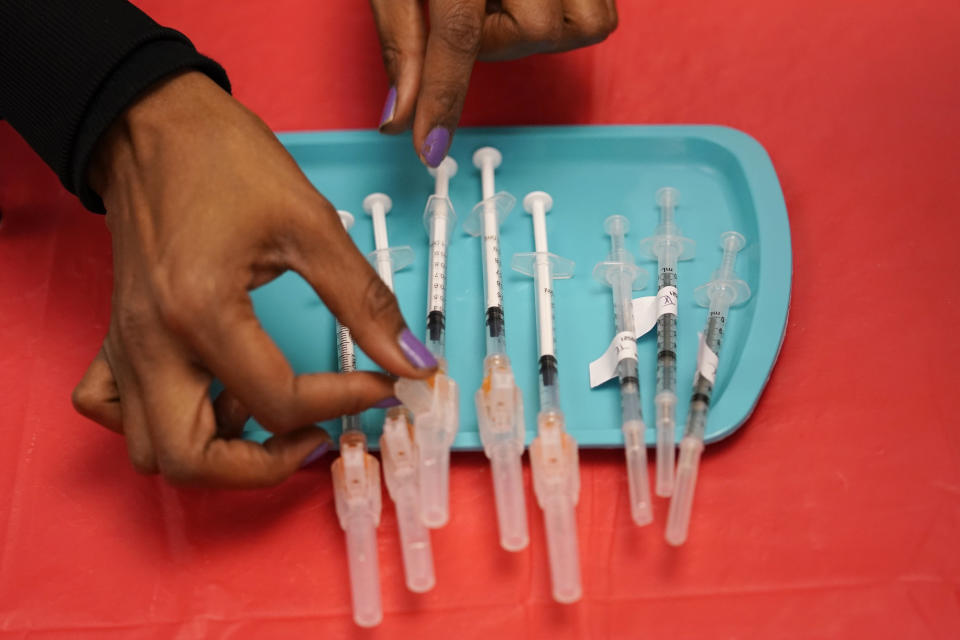 FILE - In this Jan. 22, 2021, file photo, a certified medical assistant prepares doses of the Pfizer COVID-19 vaccine at a vaccination center at the University of Nevada, Las Vegas. With more than 40 million doses of coronavirus vaccines available, U.S. health authorities said they're confident both seniors and other vulnerable Americans seeking booster shots and parents anticipating approval of initial shots for young children will have easy access. (AP Photo/John Locher, File)