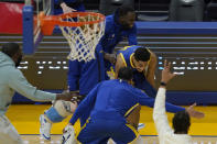 Golden State Warriors guard Jordan Poole, middle, celebrates with teammates after shooting a three-point basket at the third period buzzer during an NBA basketball game against the Utah Jazz in San Francisco, Monday, May 10, 2021. (AP Photo/Jeff Chiu)