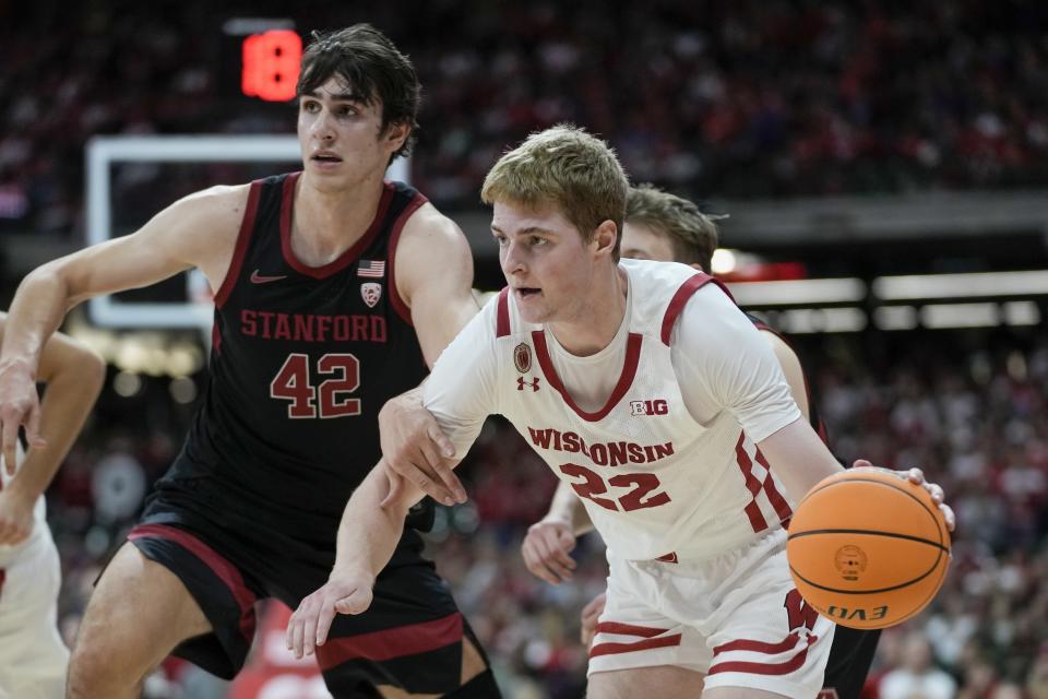 Wisconsin's Steven Crowl drives past Stanford's Maxime Raynaud during the first half of an NCAA college basketball game Friday, Nov. 11, 2022, in Milwaukee. The game is being played at American Family Field, home of the Milwaukee Brewers. (AP Photo/Morry Gash)