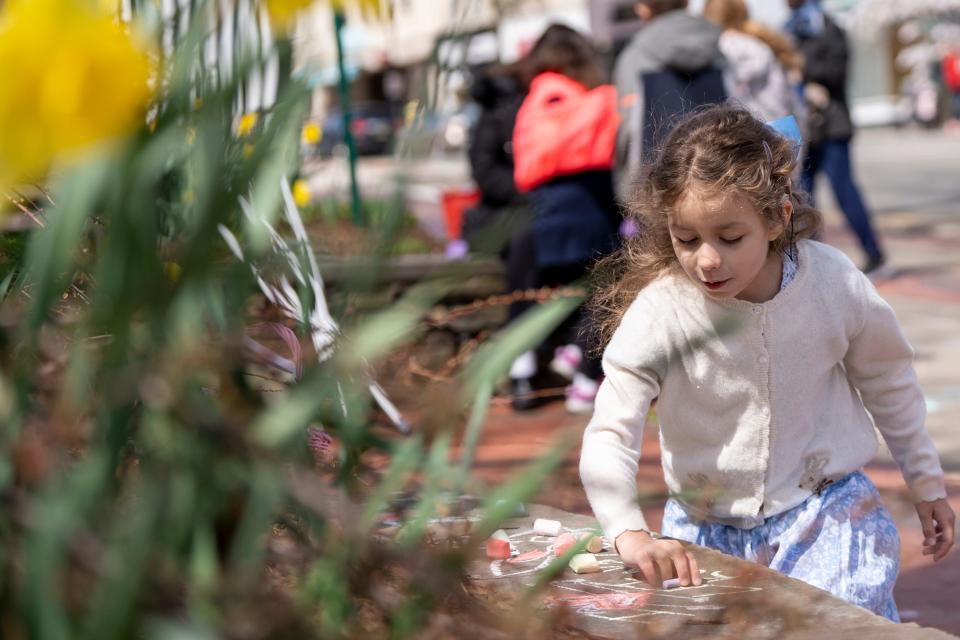 An Easter celebration is held at Memorial Park in Ridgewood, NJ on Saturday, April 8, 2023. Camilla Sos, 6 does a chalk drawing. 