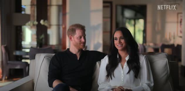 The Duke and Duchess of Sussex pictured speaking in their new docuseries, 