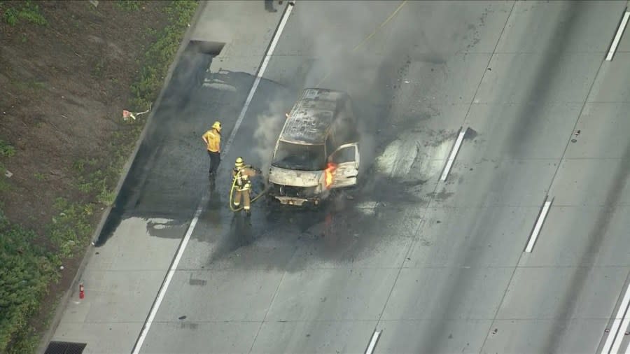 A burning van on the 105 Freeway in the City of Paramount caused delays for commuters early Monday morning. (Sky5)