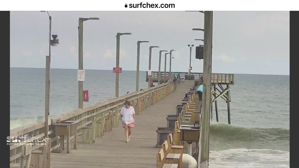 A visitor is captured on the Surf City Fishing Pier webcam Wednesday as waves roll in on the beach below. The surf is expected to be considerably higher Thursday and Friday as Hurricane Lee passes the N.C. shore.