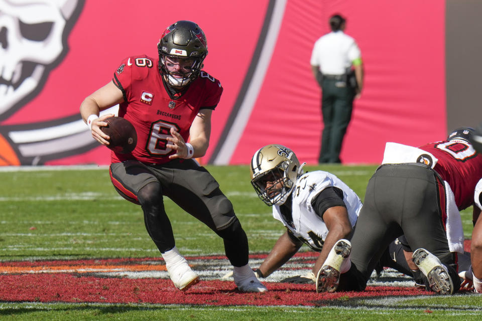 Tampa Bay Buccaneers quarterback Baker Mayfield (6) scrambles from New Orleans Saints defensive end Cameron Jordan (94) in the first half of an NFL football game in Tampa, Fla., Sunday, Dec. 31, 2023. (AP Photo/Chris O'Meara)