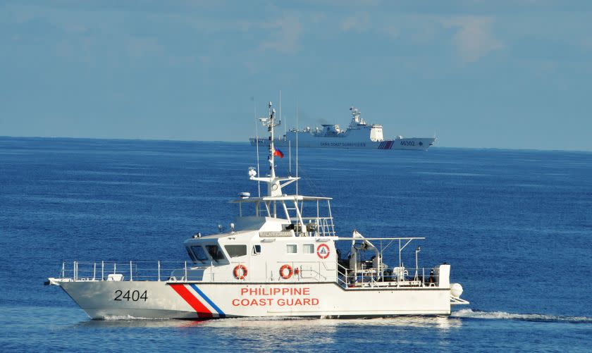 This photo taken on May 14, 2019, a Philippine coast guard ship (R) sails past a Chinese coastguard ship during an joint search and rescue exercise between Philippine and US coastguards near Scarborough shoal, in the South China Sea. - Two Philippine coastguard ships, BRP Batangas and Kalanggaman and US coastguard cutter Bertholf participated in the exercise. (Photo by TED ALJIBE / AFP) (Photo credit should read TED ALJIBE/AFP via Getty Images)