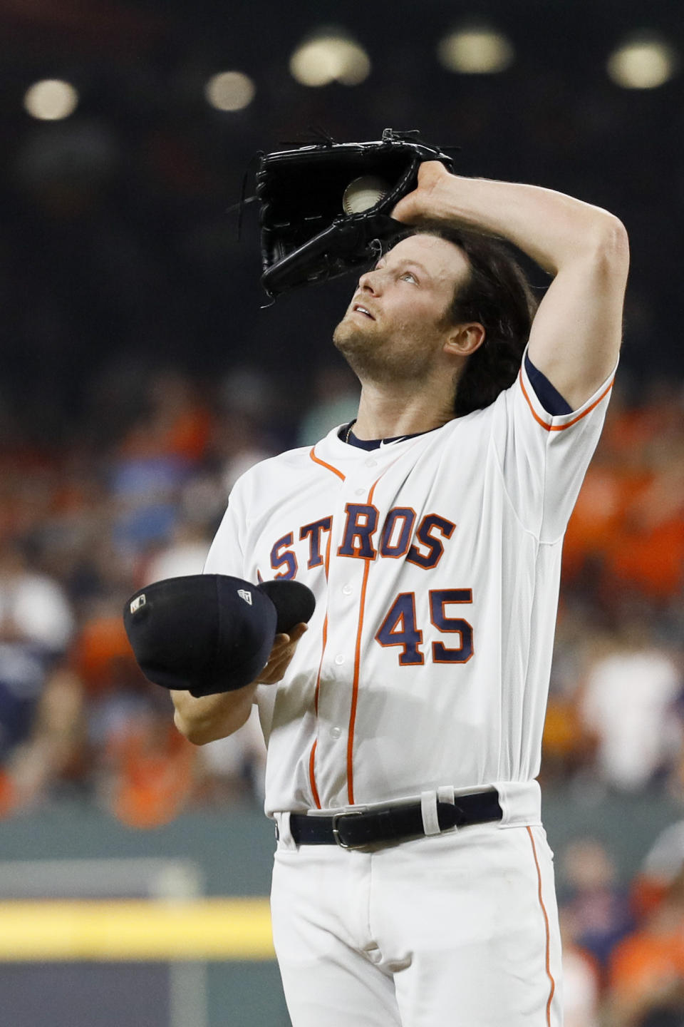 Houston Astros starting pitcher Gerrit Cole wipes his fave after giving up a double to Washington Nationals' Juan Soto during the fifth inning of Game 1 of the baseball World Series Tuesday, Oct. 22, 2019, in Houston. (AP Photo/Matt Slocum)