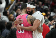 Washington Wizards forward Kyle Kuzma, left, and Los Angeles Lakers forward Anthony Davis hug after an NBA basketball game, Sunday, Dec. 4, 2022, in Washington. The Lakers won 130-119. (AP Photo/Jess Rapfogel)