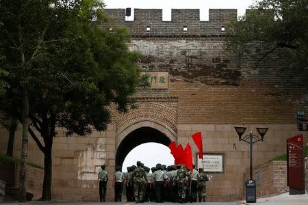 Security personnel walk through an arch underneath a section of the Great Wall before a visit by Canadian Prime Minister Justin Trudeau (not pictured) and his family in Badaling, north of Beijing, China, September 1, 2016. REUTERS/Thomas Peter