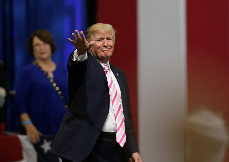 President Donald Trump waves to the crowd after speaking at a rally in Alabama where he ripped the NFL. (REUTERS)