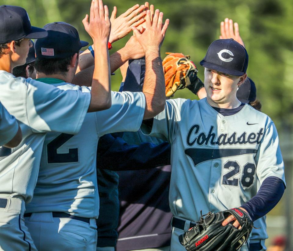 Cohasset's Collin Madden celebrates with teammates after a win over Carver on Thursday, May 12, 2022.