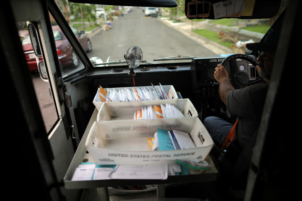 <p>Alfredo Martinez, a mail man for the U.S. Postal Service delivers the mail at an area affected by Hurricane Maria in San Juan, Puerto Rico, Oct. 6, 2017. (Photo: Carlos Barria/Reuters) </p>