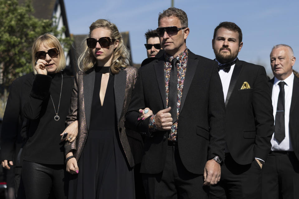 ORPINGTON, ENGLAND - APRIL 20: Wife of Tom Parker, Kelsey Parker (C-L), follows a horse-drawn hearse during a procession through Orpington before a funeral service at St Francis of Assisi church on April 20, 2022 in Orpington, England. British singer Tom Parker, a member of popular boy band The Wanted, died at the age of 33 after being diagnosed with an inoperable brain tumour. (Photo by Dan Kitwood/Getty Images)