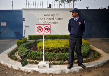 A private security guard stands outside the U.S. embassy in New Delhi December 18, 2013. REUTERS/Anindito Mukherjee