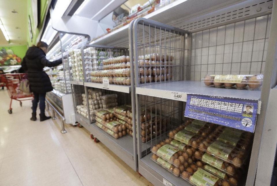 In this Wednesday, Dec. 28, 2016 photo, a customer looks at eggs at a discount store in Seoul, South Korea. Egg prices are soaring and new year's festivals are being canceled as South Korea fights its worst bird flu outbreak in over a decade. South Korea's government said Tuesday that about 26 million head of poultry will be culled by Wednesday including about one-third of the country's egg-laying hens after the H5N6 strain of avian influenza was found in farms and parks. (AP Photo/Ahn Young-joon, File)