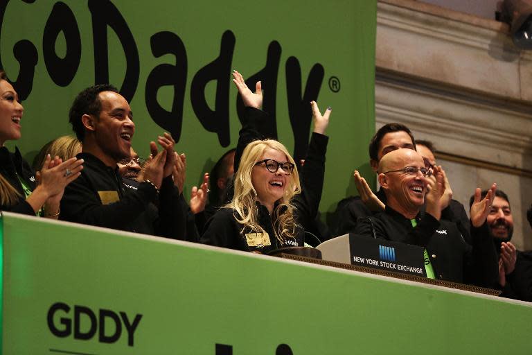 GoDaddy CEO Blake Irving (R) cheers at the opening bell on the floor of the New York Stock Exchange as the website hosting service makes its initial public offering on April 1, 2015 in New York