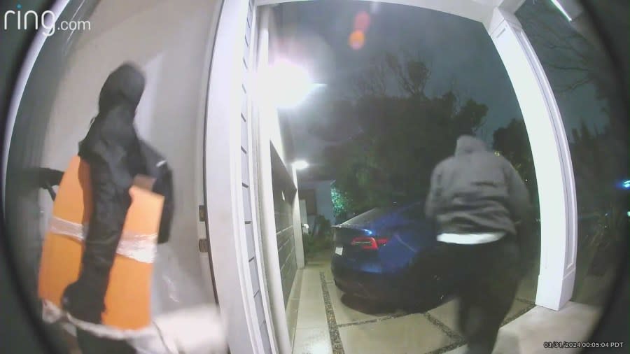Burglars running out the front door after stealing items from a Westchester home. 