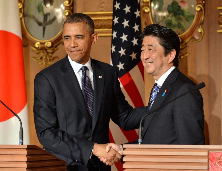 US President Barack Obama (L) shakes hands with Japanese Prime Minister Shinzo Abe following a bilateral press conference at the Akasaka Palace in Tokyo on April 24, 2014