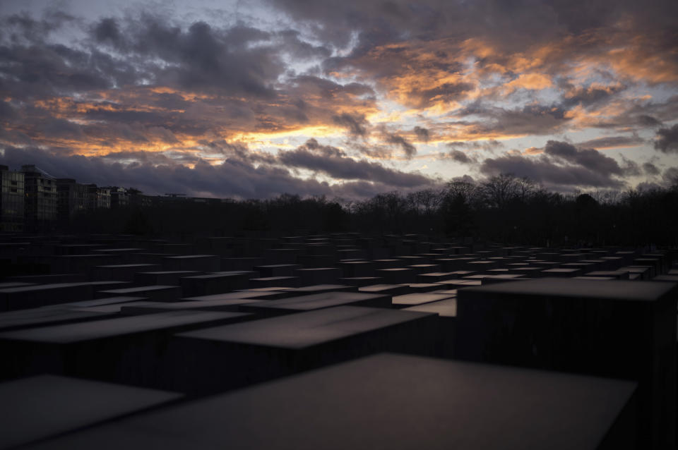 The sun sets behind the Holocaust Memorial at the eve of the International Holocaust Remembrance Day in Berlin, Germany, Friday, Jan. 26, 2024. The International Holocaust Remembrance Day marking the anniversary of the liberation of the Nazi death camp Auschwitz - Birkenau on Jan. 27, 1945. (AP Photo/Markus Schreiber)