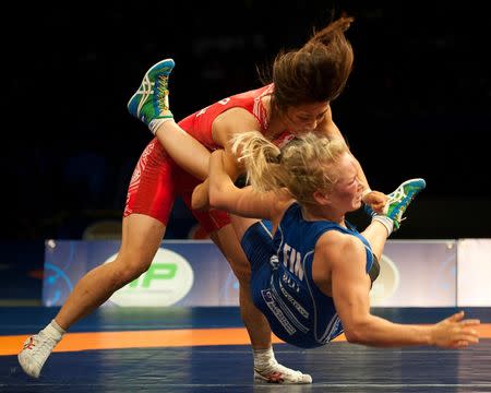 Sep 10, 2015; Las Vegas, NV, USA; Kaori Icho of Japan (red) throws Petra Maarit Olli of Finland (blue) to the mat on the fourth night of the World Wrestling Championships at The Orleans Arena. Mandatory Credit: Stephen R. Sylvanie-USA TODAY Sports