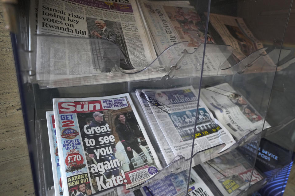 Newspapers on display for sale, in London, Tuesday, March 19, 2024. A British newspaper says Prince William and his wife Catherine have been filmed at a farm shop near their Windsor home. It's the first reported footage of Kate since she had abdominal surgery for an unspecified condition two months ago. The Sun published a short clip late Monday that appeared to show the couple smiling as they walked together, carrying shopping bags. It said the footage was taken on Saturday. (AP Photo/Kirsty Wigglesworth)