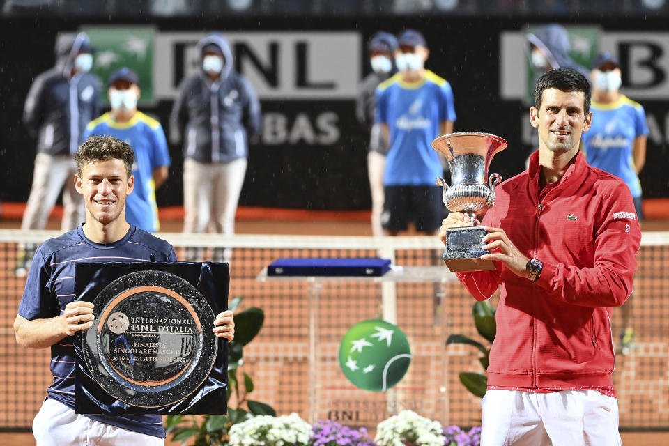 Serbia's Novak Đjoković, right, celebrates winning his match with Argentina's Diego Sebastián Schwartzman, left, during their final match at the Italian Open tennis tournament, in Rome, Monday, Sept. 21, 2020. (Alfredo Falcone/LaPresse via AP)