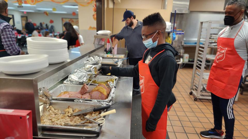 A young volunteer prepares to serve a Thanksgiving meal Thursday for residents of the Salvation Army Shelter in downtown Amarillo.