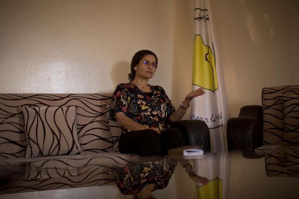 In this Tuesday, Sept. 3, 2019 photo, Ilham Ahmed, co-chair of the executive committee of the U.S-backed Syrian Democratic Council, speaks during an interview in Darbasiyah, Syria. Ahmed said Tuesday that the creation of a so-called “safe zone” in northeastern Syria is off to good start, with U.S.-backed Kurdish-led forces pulling back from an initial part of the border with Turkey, but calm can only prevail if Turkey also removes its troops. (AP Photo/Maya Alleruzzo)