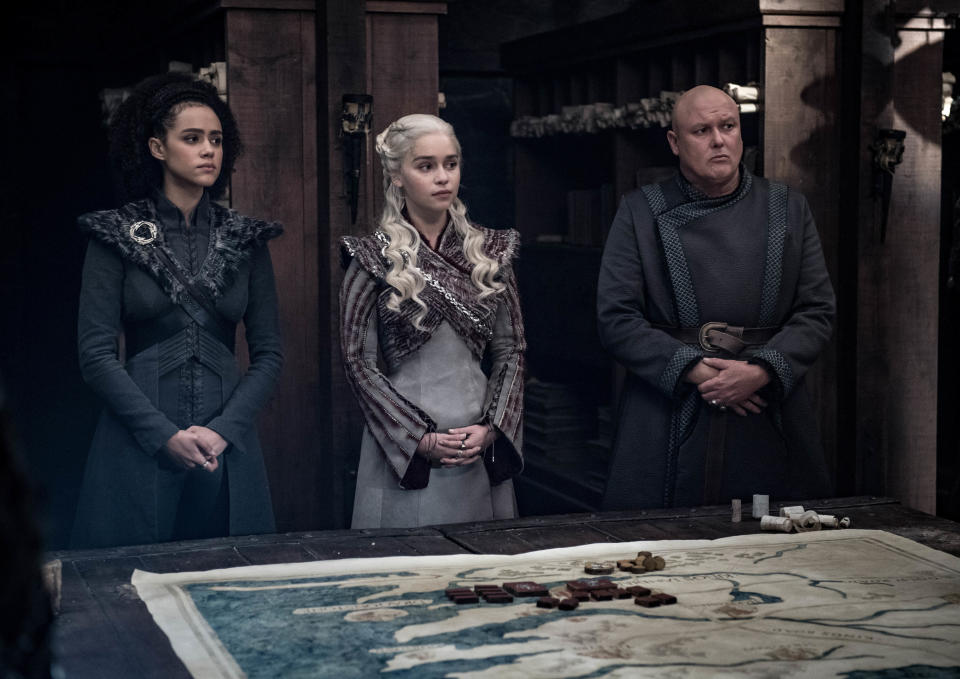 This image released by HBO shows from left, Nathalie Emmanuel, Emilia Clarke and Conleth Hill in a scene from "Game of Thrones," that aired Sunday, May 5, 2019. In the third to last episode of HBO’s “Game of Thrones,” Mother of Dragons Daenerys Targaryen is suffering from a crisis of confidence. She is short on troops and dragons, short on strategies and short on friends. And her claim to the Iron Throne has weakened upon learning that Jon Snow, in fact, shares her royal Targaryen blood. (Helen Sloan/HBO via AP)